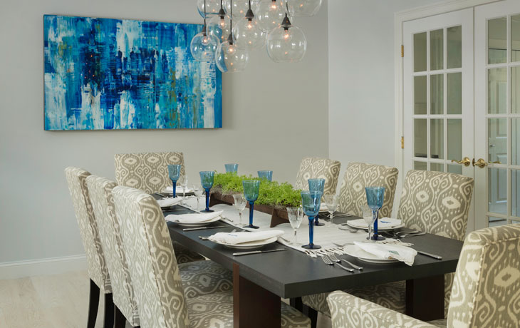 Formal dining can accommodate larger parties in a beachside home by Blue Jay Design of Wellesley, MA