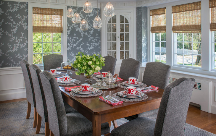 Custom wall paper and hand-blown glass chandelier add shimmer to a traditional dining room by Blue Jay Design of Wellesley, MA