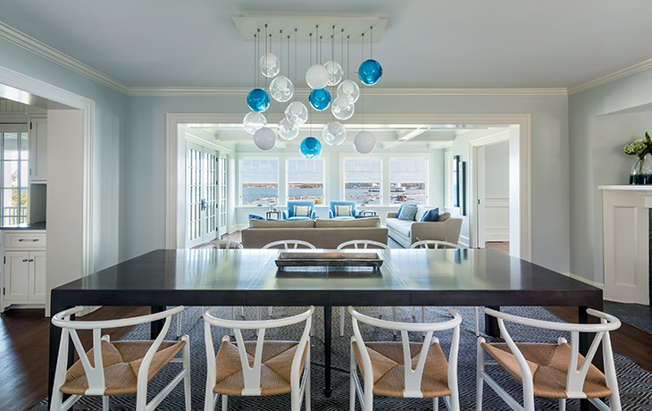 Contemporary artwork and furnishings provide a striking contrast to the traditional architecture by Blue Jay Design of Wellesley, MA