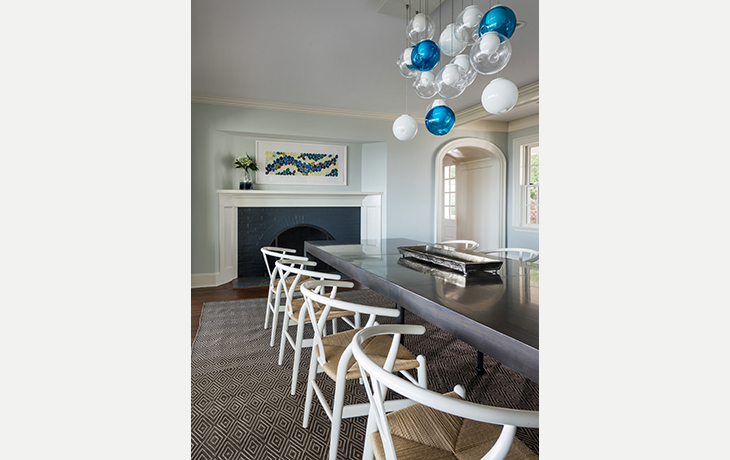 A dazzling custom-designed blue and white glass chandelier adds light and whimsy to the elegant dining area by Blue Jay Design of Wellesley, MA