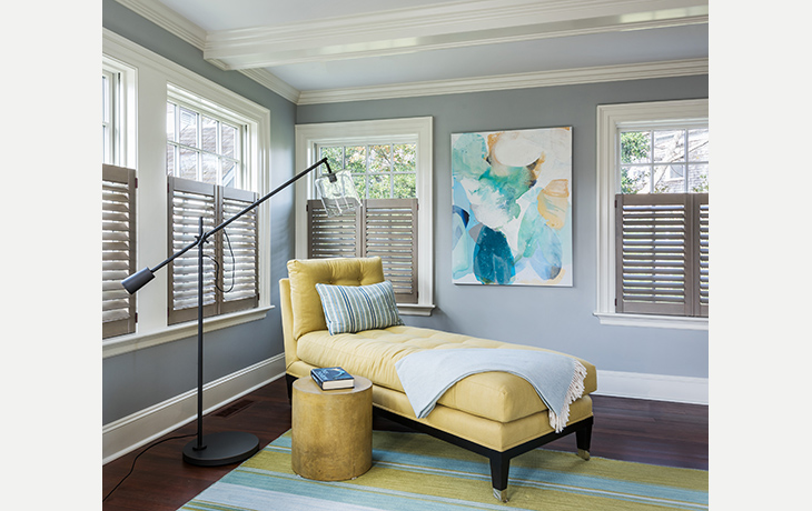 A vibrantly colored chaise offers the perfect spot to enjoy a summer read by Blue Jay Design of Wellesley, MA