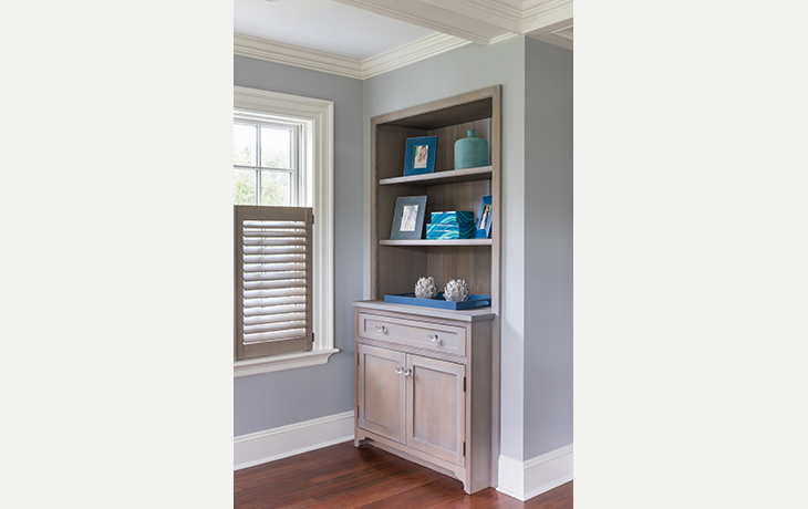 The soft gray-wash finish of the custom cabinetry and shutters contrasts with the fresh, white millwork by Blue Jay Design of Wellesley, MA