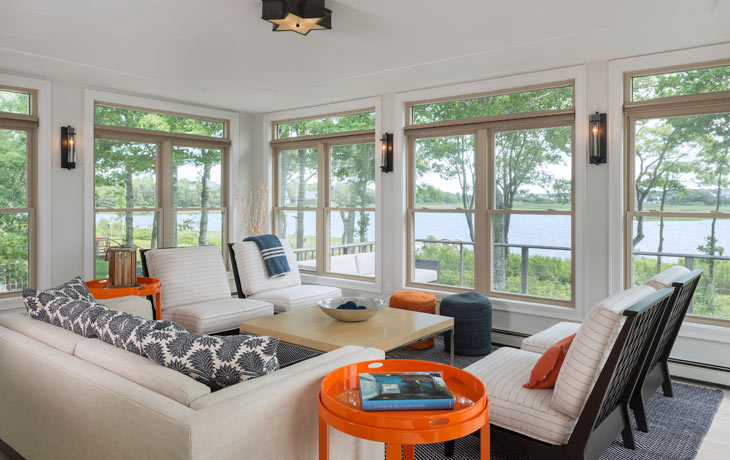 Casual beachside sunroom furnished to take in the views by Blue Jay Design of Wellesley, MA