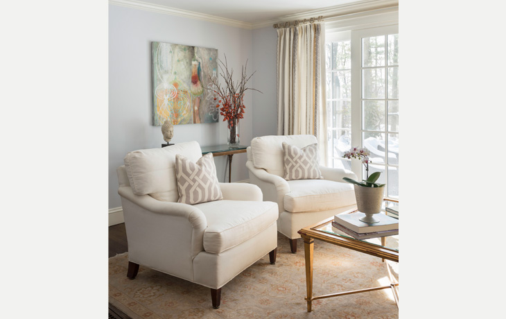 Graphic elements in the artwork and textiles add interest to a family room by Blue Jay Design of Wellesley, MA