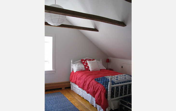 Simple furnishings and colors in a cozy country bedroom by Blue Jay Design of Wellesley, MA