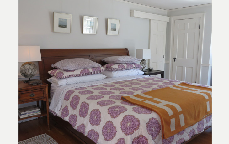 Bold graphic linens contrast tailored furnishings in a master bedroom by Blue Jay Design of Wellesley, MA